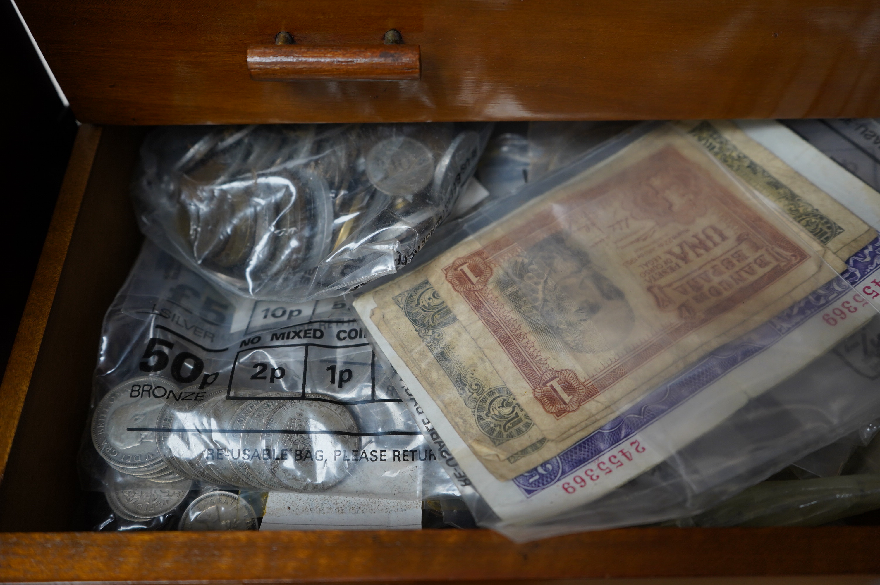 Coins, medals, medallions and badges, mainly 20th century British and European issue contained within a wooden cabinet, together with three leather boxes with padddd and lined interiors. Condition - fair.